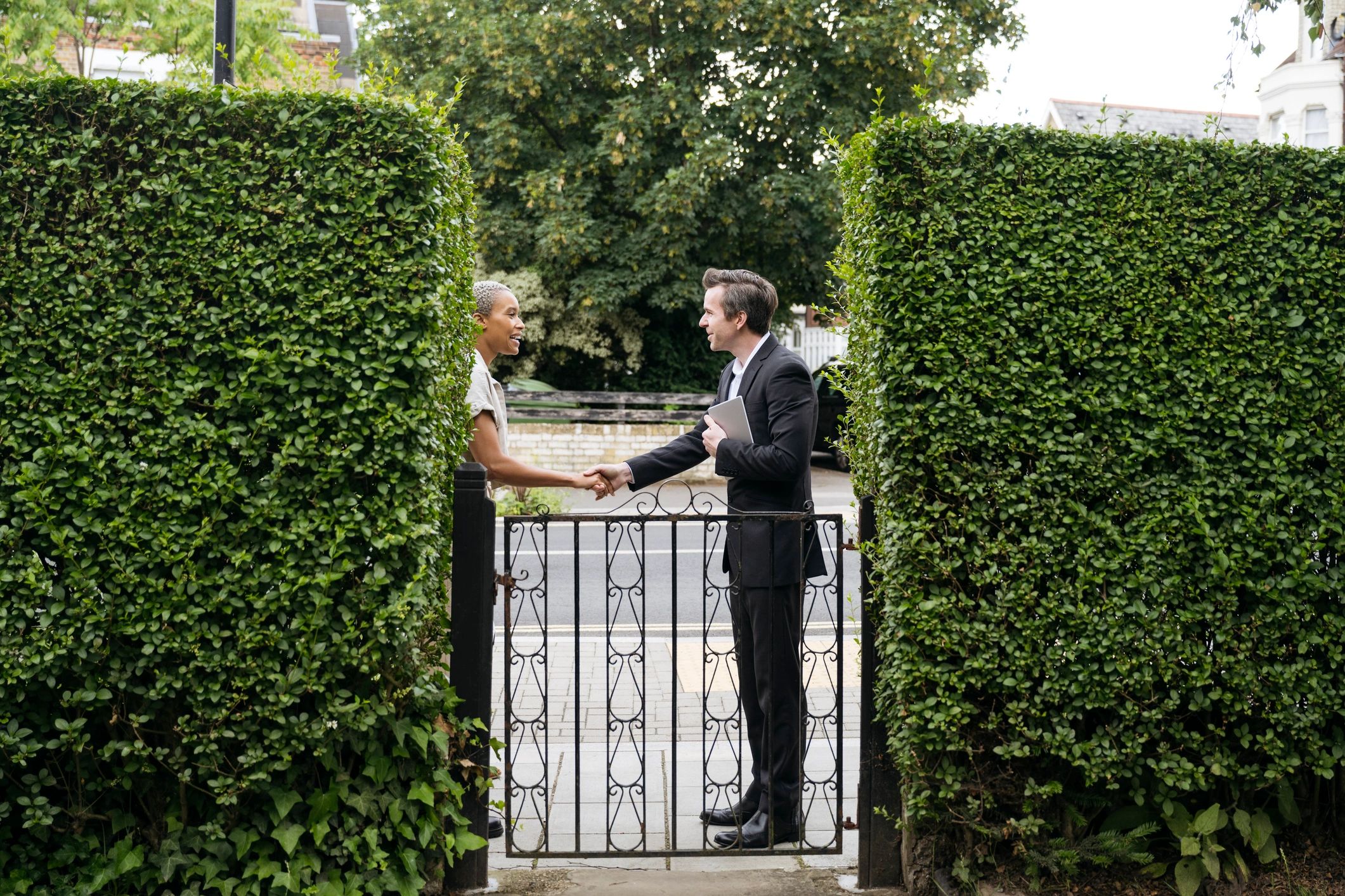 Smiling homeowner at a property entrance