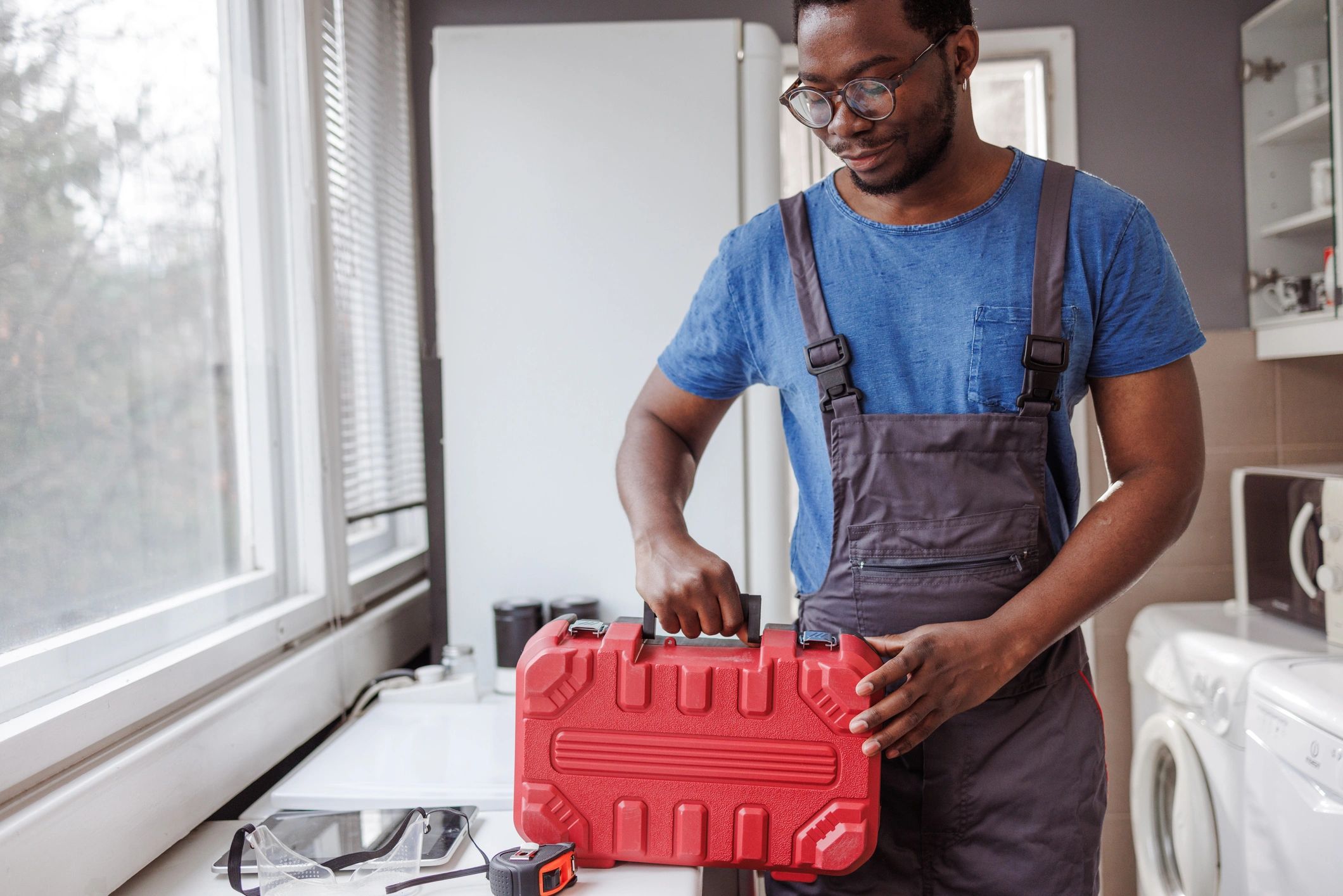Handyman holding a toolbox ready for a repair